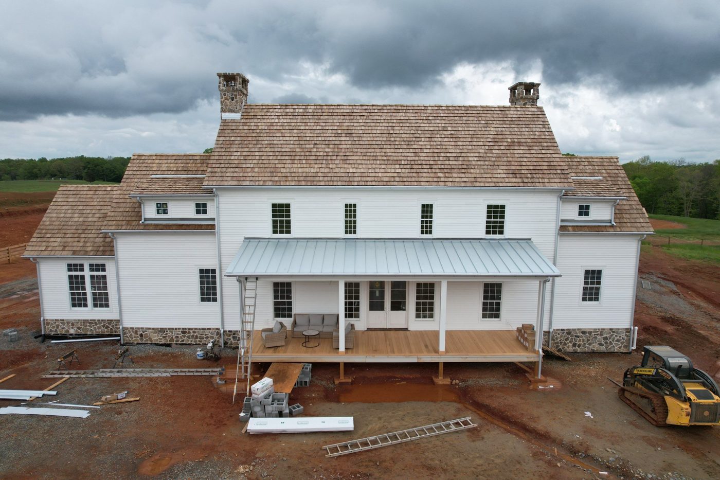 Cedar shake roof with stone chimneys on a new construction home