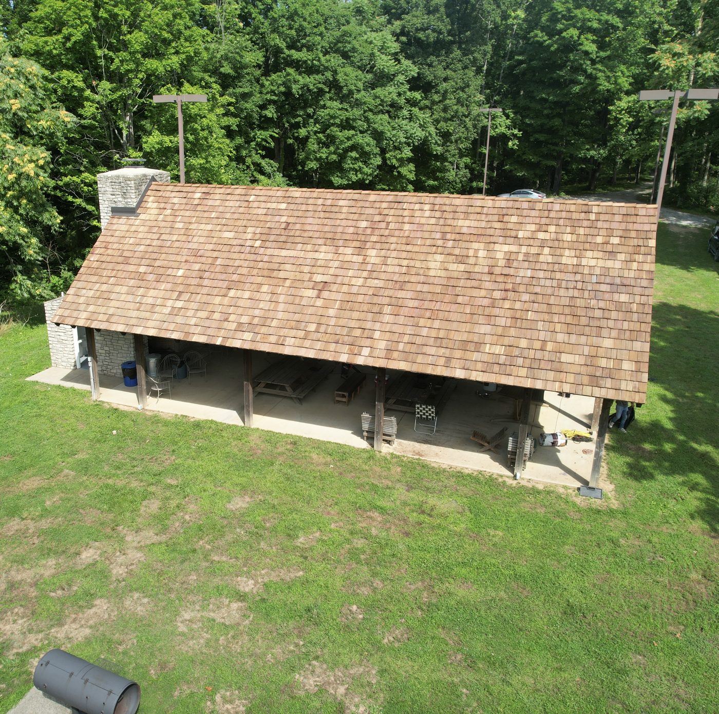 Cedar shake roof on an outdoor pavilion with a stone chimney