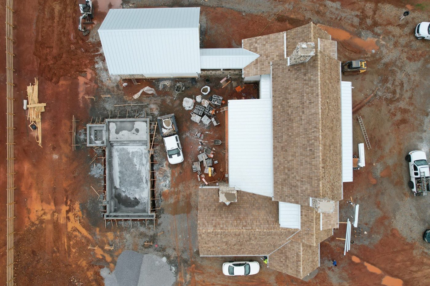 Aerial view of a new construction home with roofing in progress